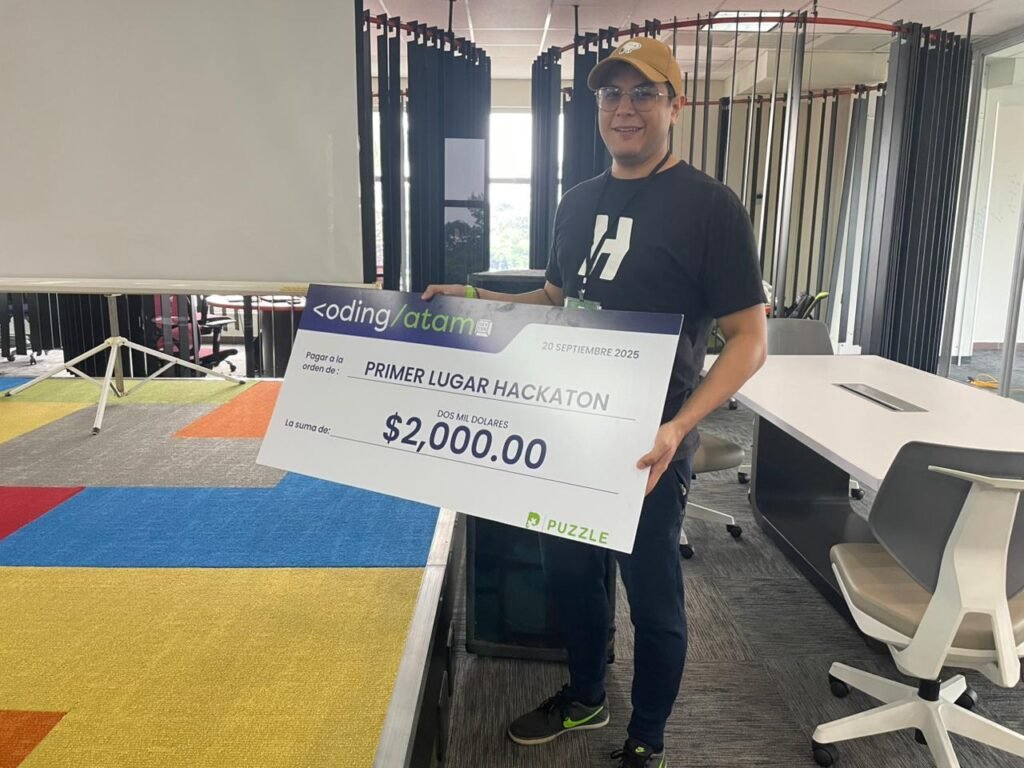 Me holding a grand prize of $2000 from a Hackathon